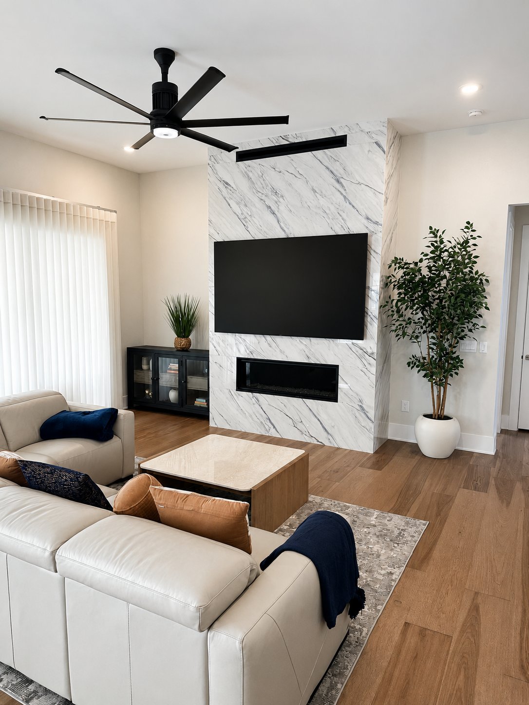85 inch LG OLED TV on full-motion mount above white quartz fireplace Cary NC