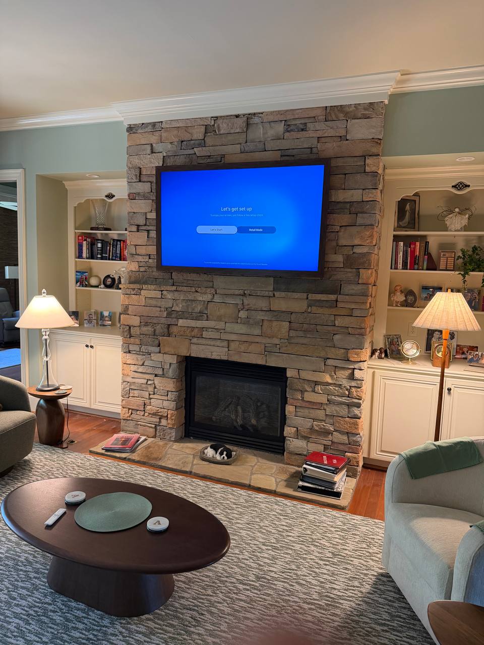 65-inch Samsung The Frame TV above uneven manufactured stone fireplace in Apex NC
